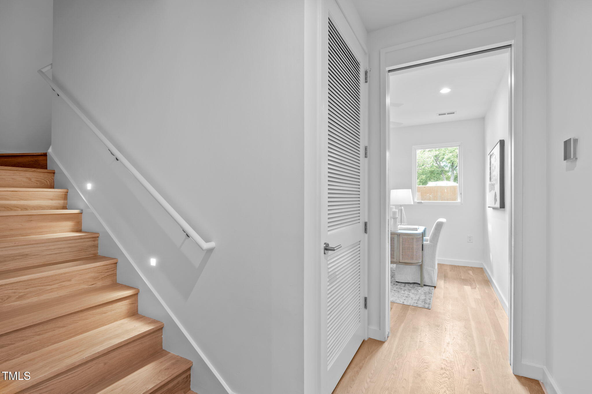 511 South Bloodworth Street, Unit 102 Raleigh, NC 27601 - Photo 31 of 54 a view of a hallway with wooden floor and staircase