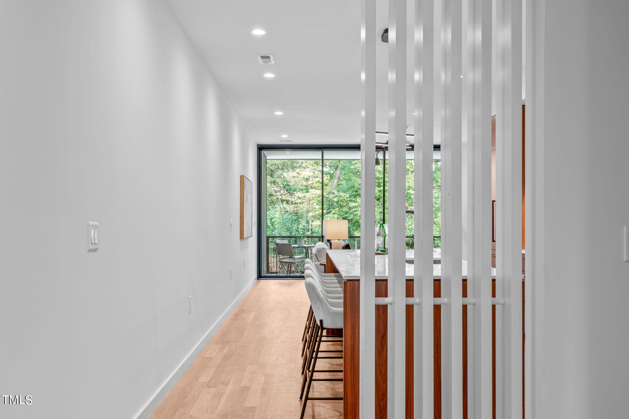 511 South Bloodworth Street, Unit 102 Raleigh, NC 27601 - Photo 5 of 54 a view of a porch with wooden floor and stairs