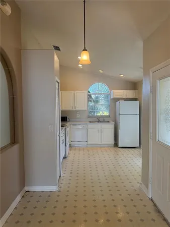 a view of a kitchen with a sink and cabinets