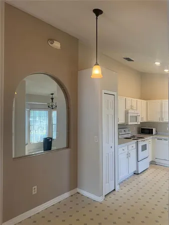 a kitchen with stainless steel appliances granite countertop a sink a stove and a wooden floors