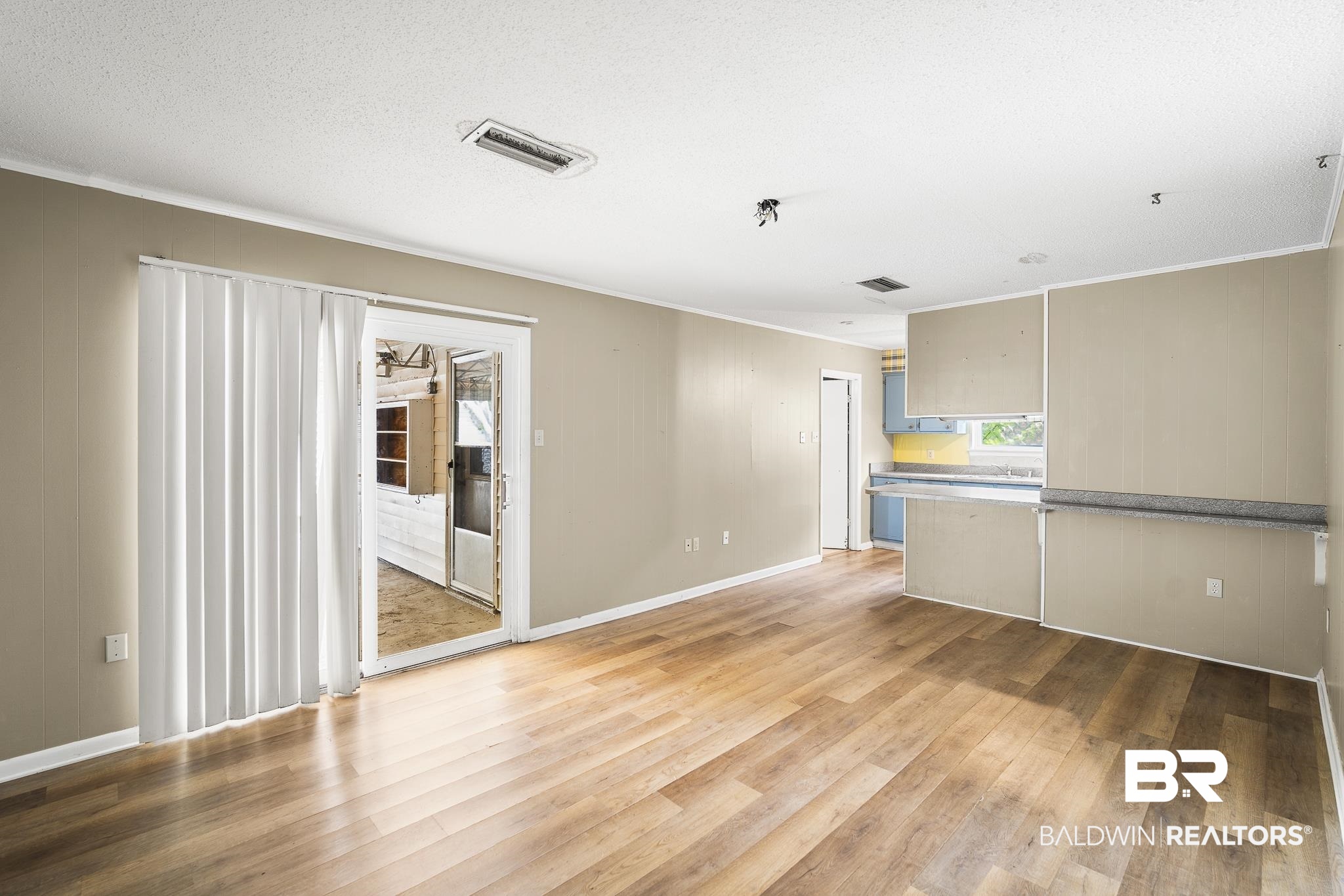 2710 Longleaf Drive Mobile, AL 36693 - Photo 2 of 27 Unfurnished room featuring light hardwood / wood-style floors and a textured ceiling
