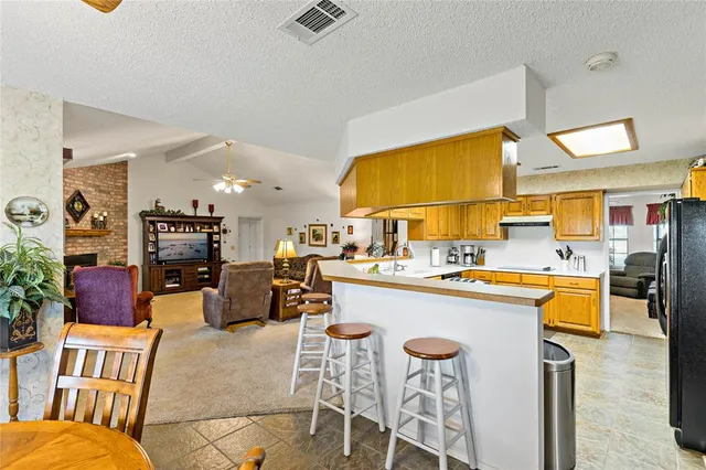 a living room with stainless steel appliances kitchen island granite countertop furniture and a kitchen view