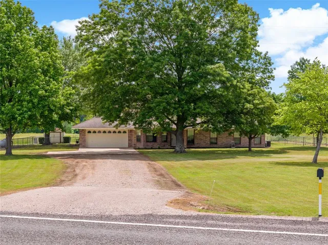 a view of a swimming pool and a yard with trees