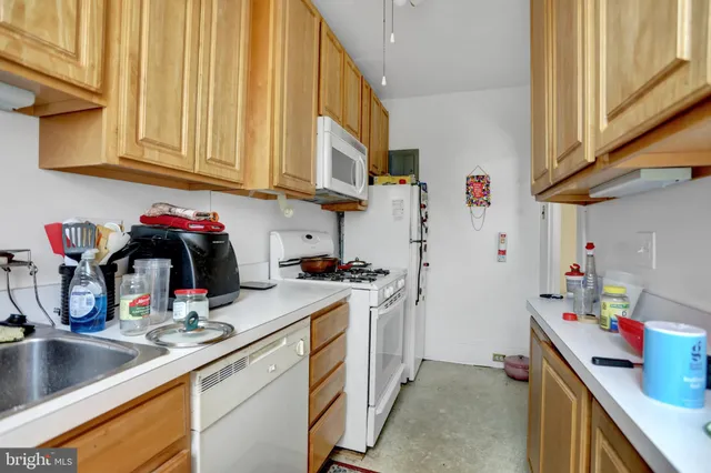 a kitchen with a sink cabinets and appliances