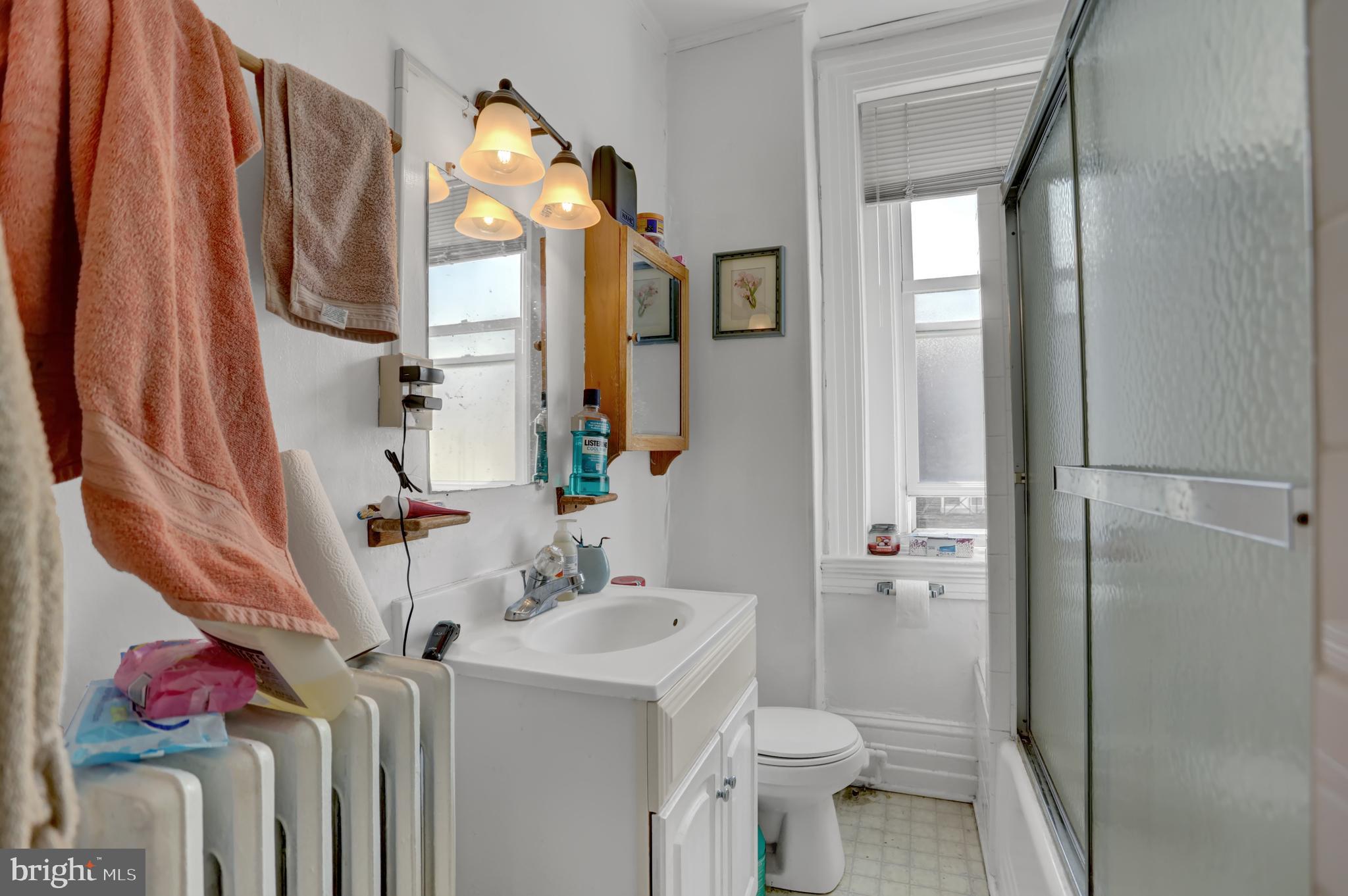 3001 North Calvert Street Baltimore, MD 21218 - Photo 12 of 44 a bathroom with a sink toilet and shower