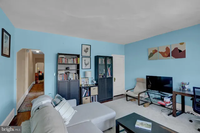 a view of a livingroom with workspace and a couch
