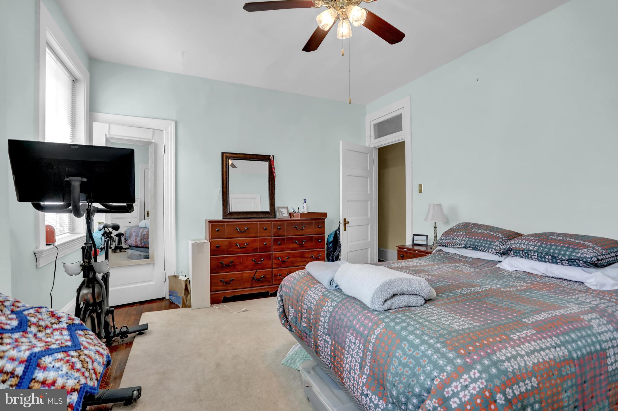 3001 North Calvert Street Baltimore, MD 21218 - Photo 18 of 44 a bedroom with a bed and a flat tv screen on dresser