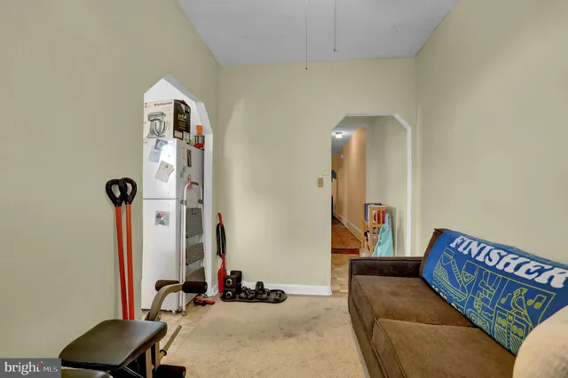 a living room with furniture and a mirror