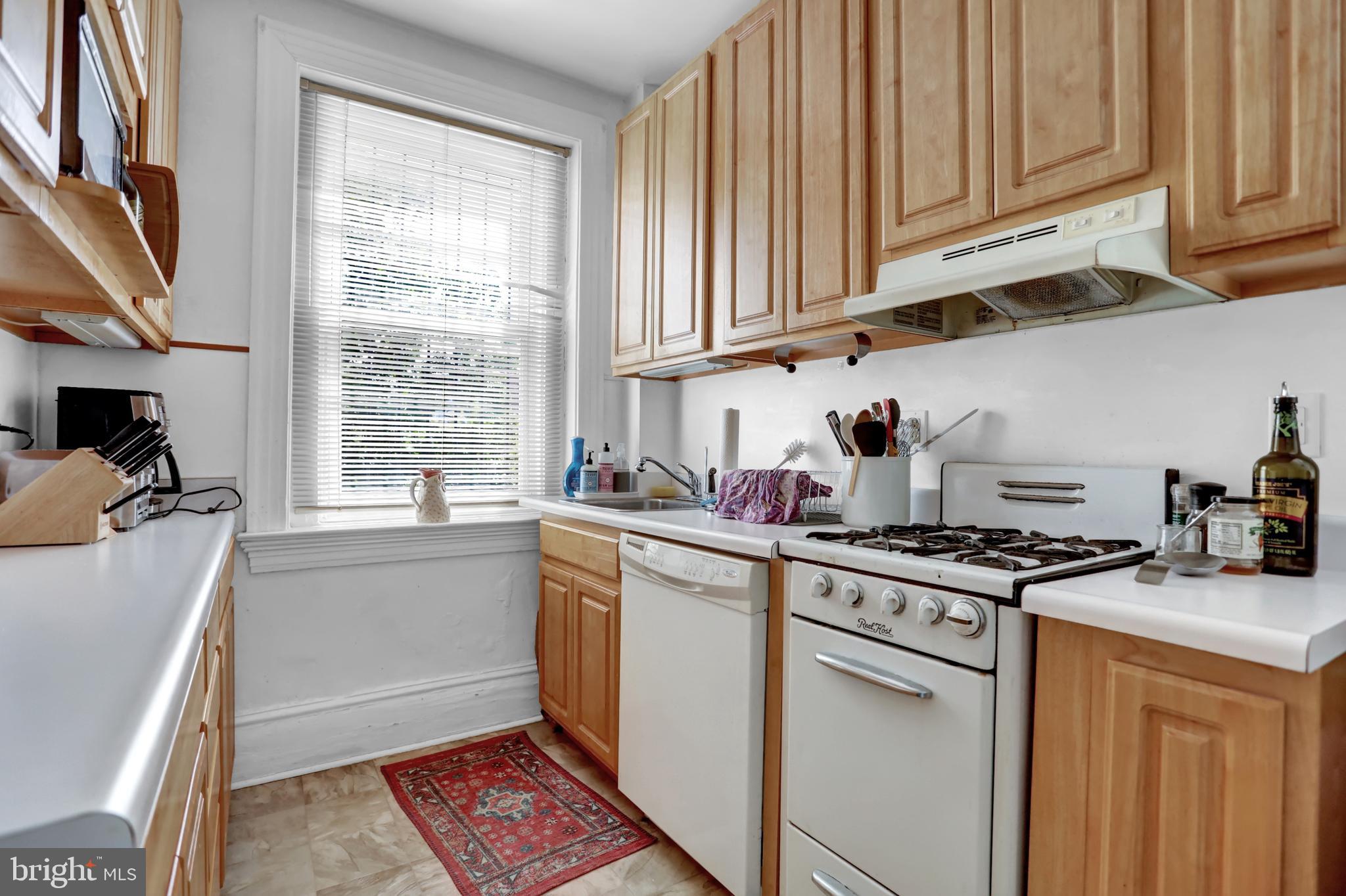 3001 North Calvert Street Baltimore, MD 21218 - Photo 22 of 44 a kitchen with stainless steel appliances granite countertop a sink stove and cabinets