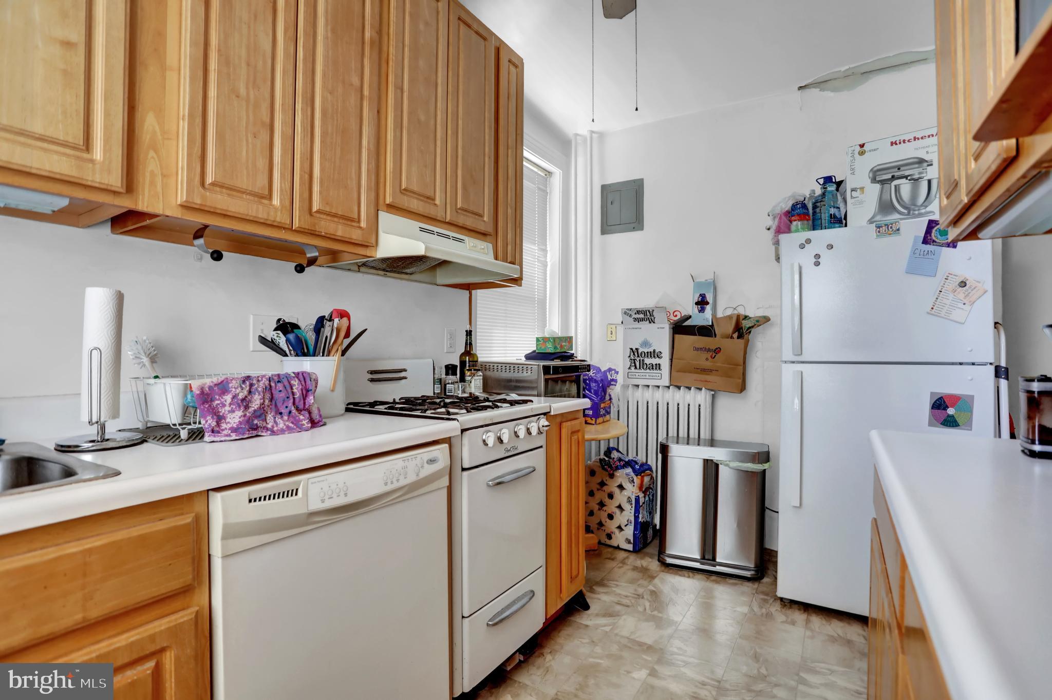 3001 North Calvert Street Baltimore, MD 21218 - Photo 23 of 44 a kitchen with refrigerator and cabinets