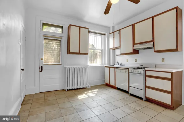 a kitchen with a stove a sink and a refrigerator