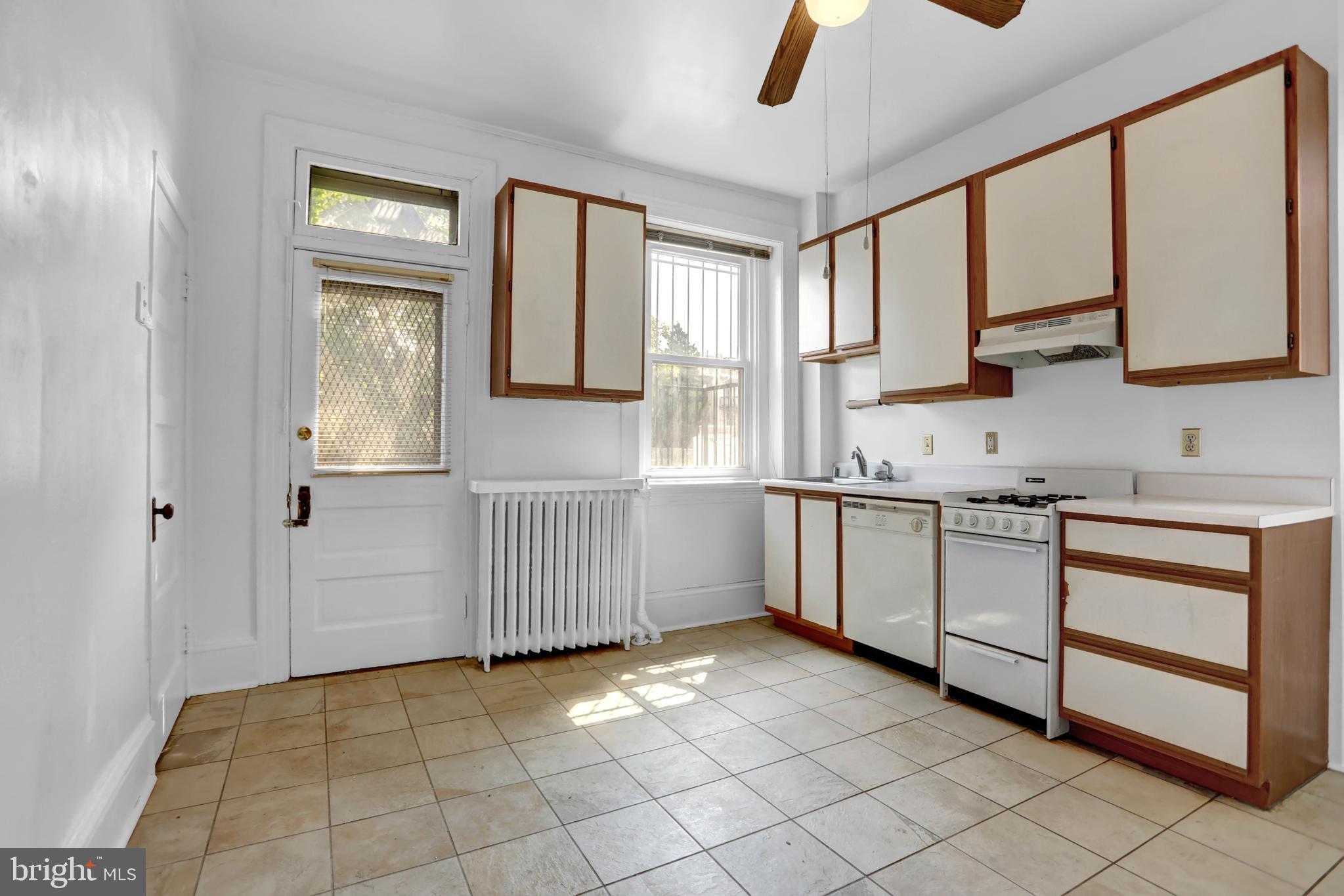 3001 North Calvert Street Baltimore, MD 21218 - Photo 25 of 44 a kitchen with a stove a sink and a refrigerator