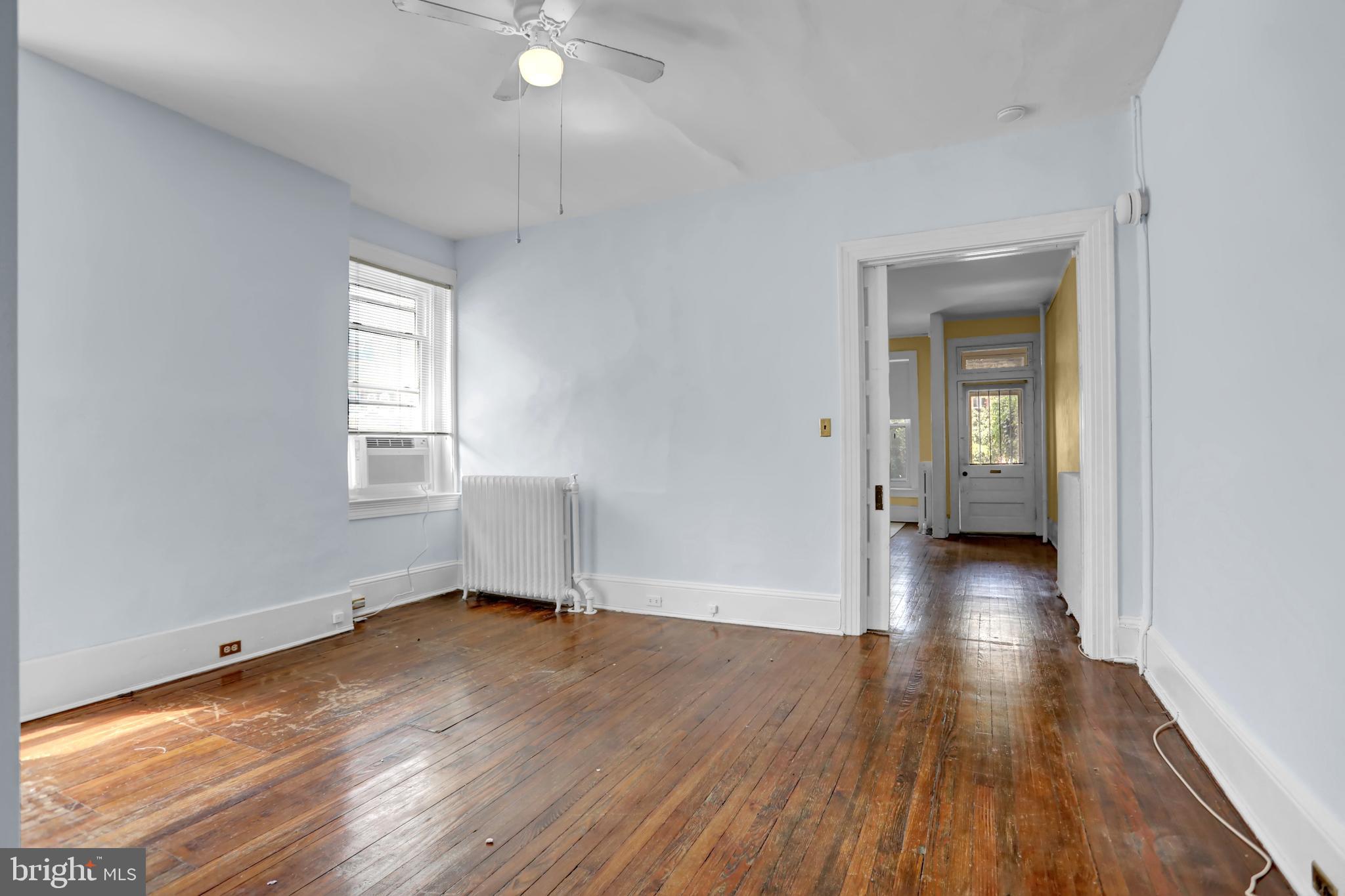 3001 North Calvert Street Baltimore, MD 21218 - Photo 28 of 44 wooden floor in an empty room with a window