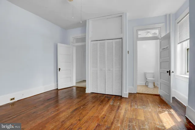 a view of a room with wooden floor and white walls