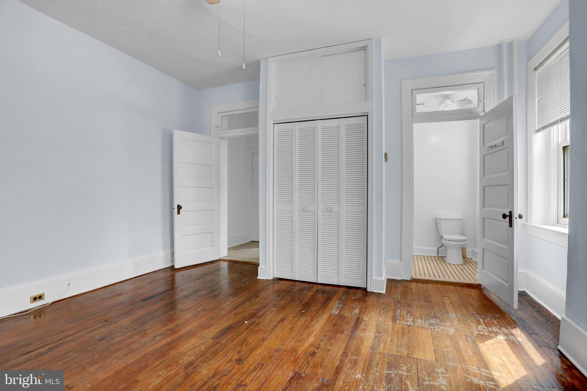 3001 North Calvert Street Baltimore, MD 21218 - Photo 29 of 44 a view of a room with wooden floor and white walls