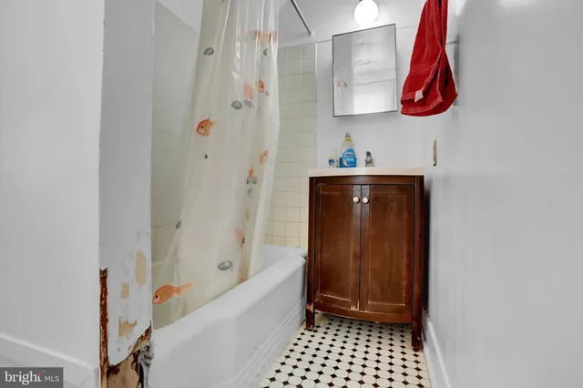 a bathroom with a sink a bath tub and shower