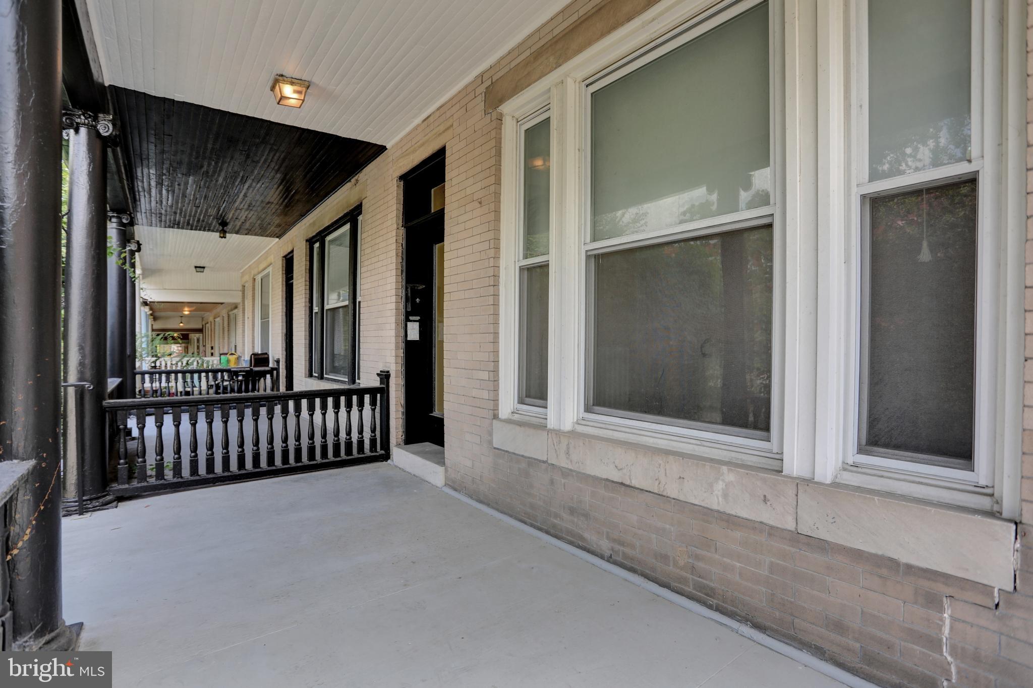 3001 North Calvert Street Baltimore, MD 21218 - Photo 3 of 44 a view of a hallway with wooden floor and windows