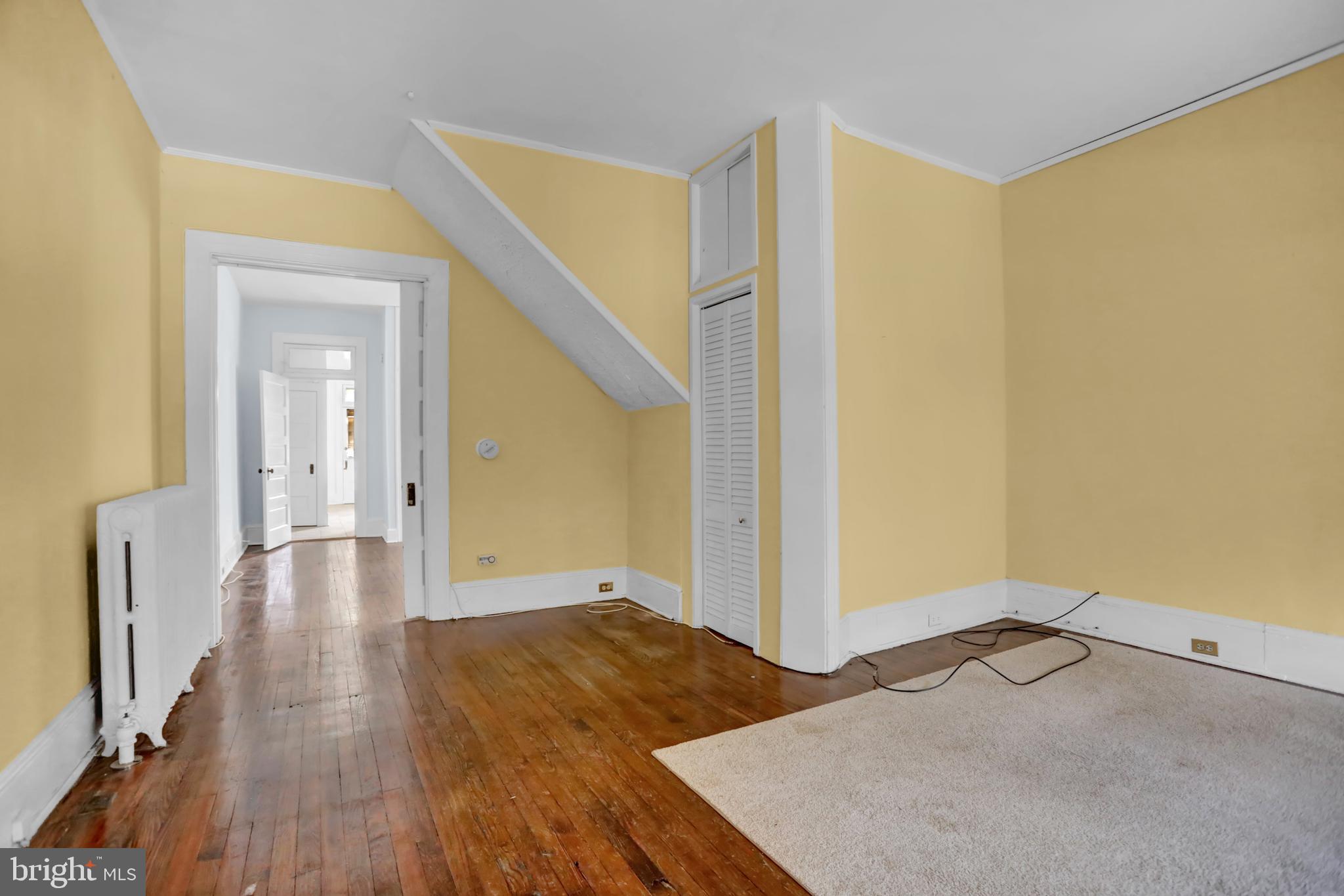 3001 North Calvert Street Baltimore, MD 21218 - Photo 32 of 44 a view of a big room with wooden floor and windows