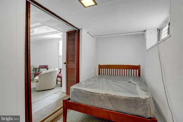 a bedroom with a bed and a couch