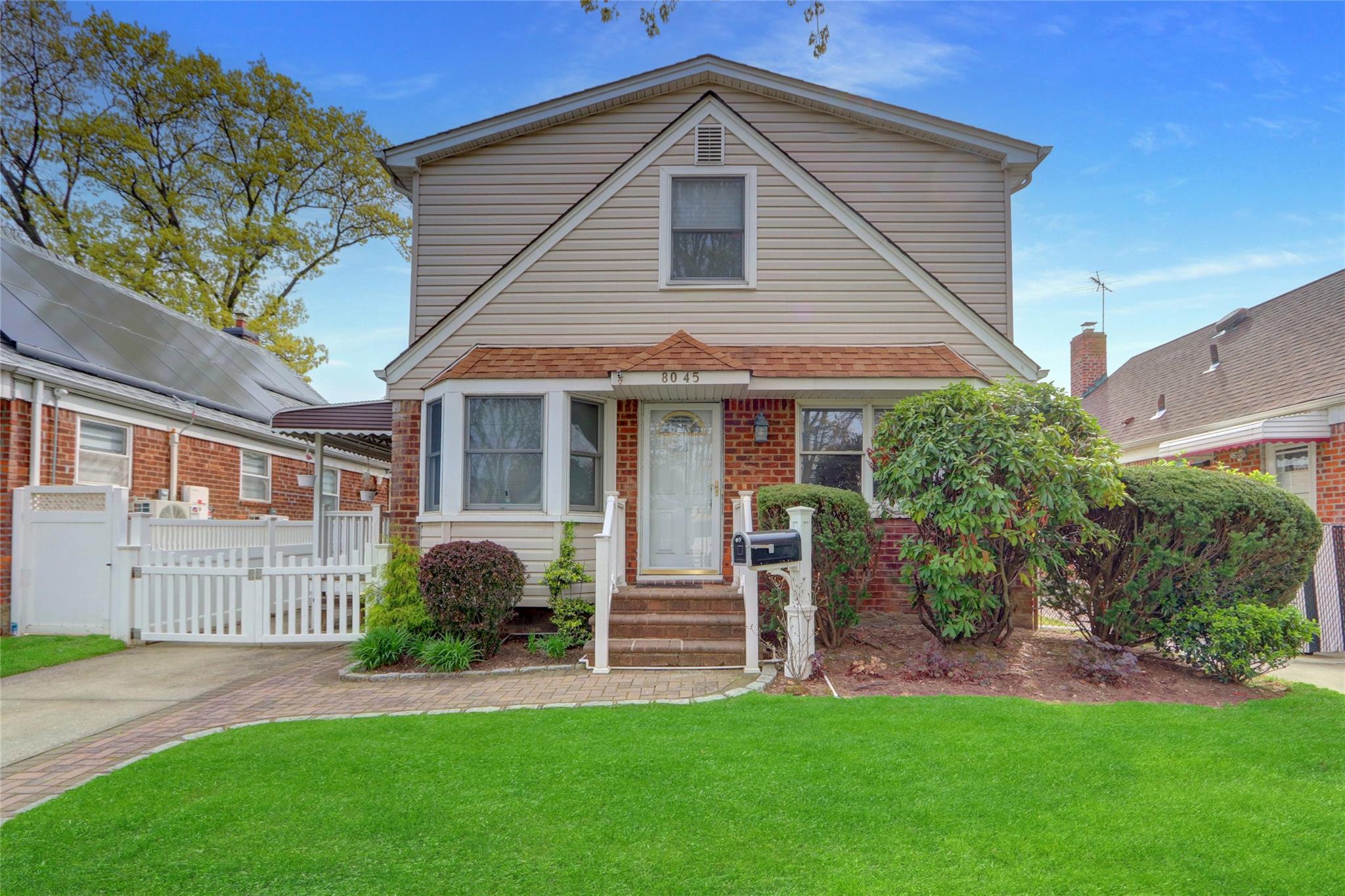 80-45 259th Street Queens, NY 11004 - Photo 1 of 1 a front view of a house with a garden and plants
