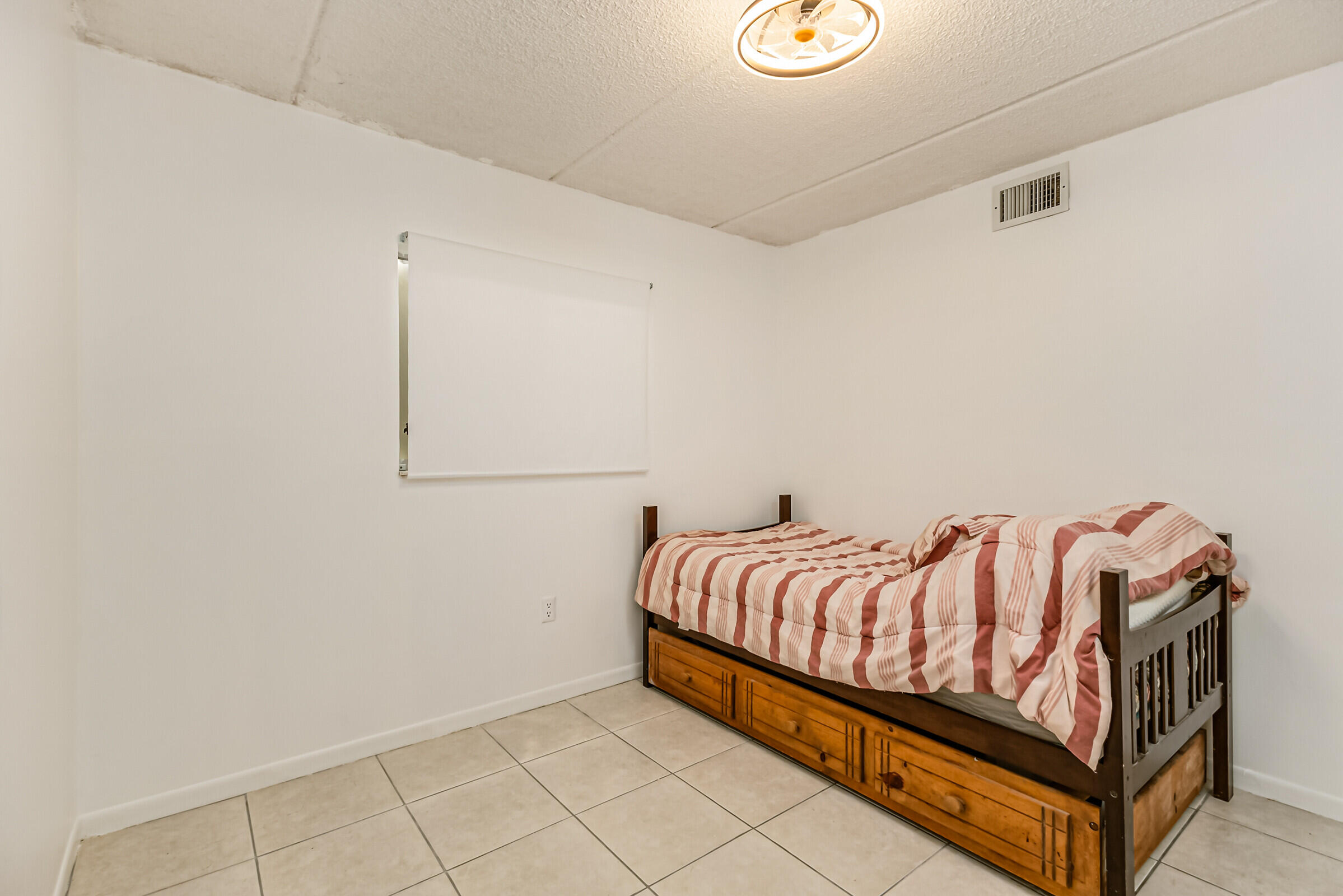 720 Ridge Club Drive, Unit 43 Melbourne, FL 32934 - Photo 20 of 27 a bedroom with a bed and a window