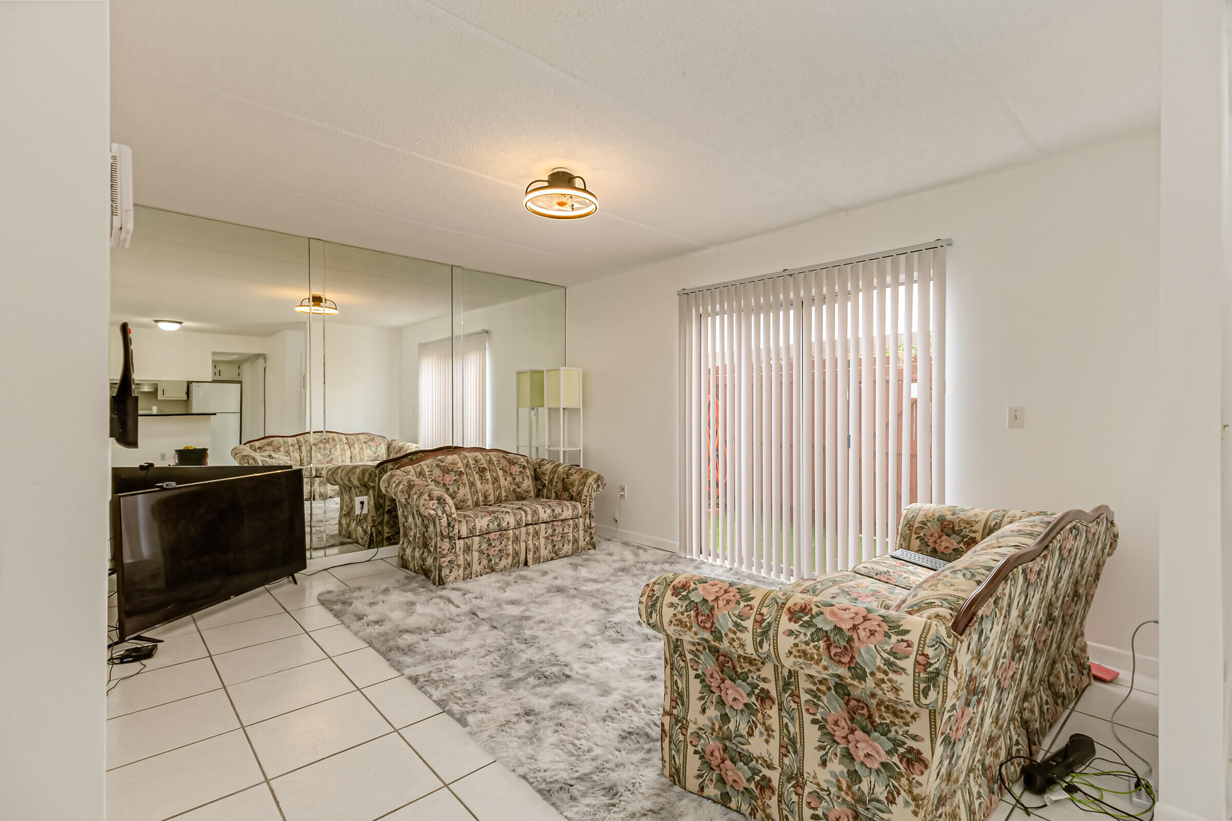 720 Ridge Club Drive, Unit 43 Melbourne, FL 32934 - Photo 21 of 27 a living room with furniture and a large window
