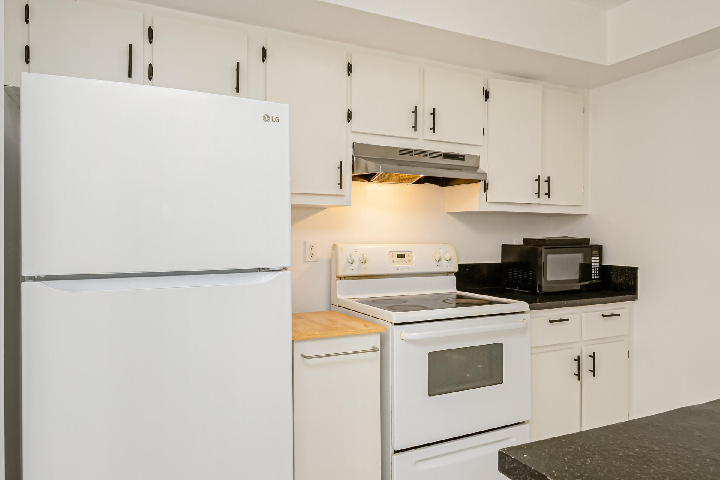 720 Ridge Club Drive, Unit 43 Melbourne, FL 32934 - Photo 24 of 27 a kitchen with refrigerator a stove a microwave and cabinets