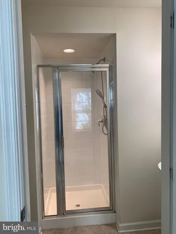 a bathroom with a glass shower door