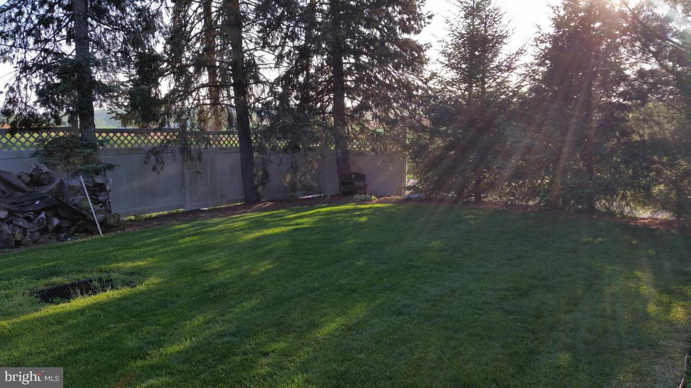 2293 North Colebrook Road Manheim, PA 17545 - Photo 17 of 17 a backyard of a house with lots of green space and garden
