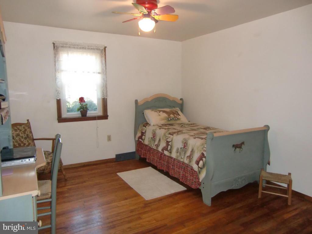 2293 North Colebrook Road Manheim, PA 17545 - Photo 9 of 17 a bedroom with a bed and a workspace