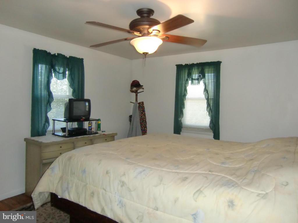 2293 North Colebrook Road Manheim, PA 17545 - Photo 10 of 17 a bedroom with a bed and a chandelier