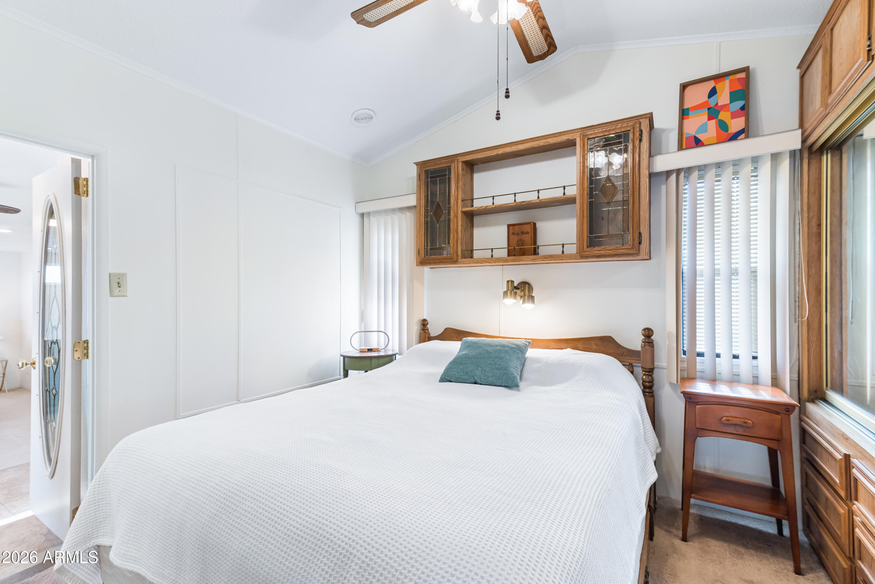 111 South Greenfield Road, Unit 547 Mesa, AZ 85206 - Photo 15 of 38 a bedroom with a large bed and a chandelier