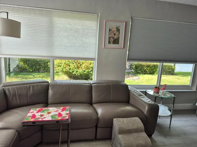 a bedroom with furniture and a large window