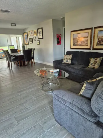 a living room with furniture and painting on the wall