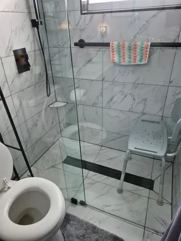 a bathroom with a toilet and a shower