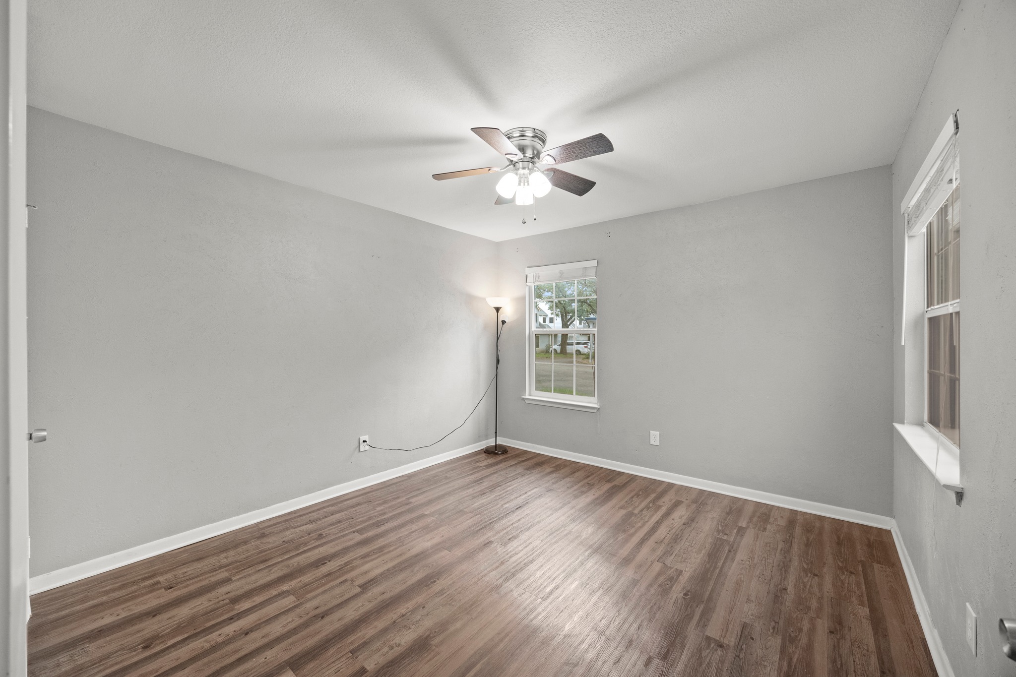 8330 Fathom Circle, Unit 501 Austin, TX 78750 - Photo 11 of 26 wooden floor in an empty room with a window
