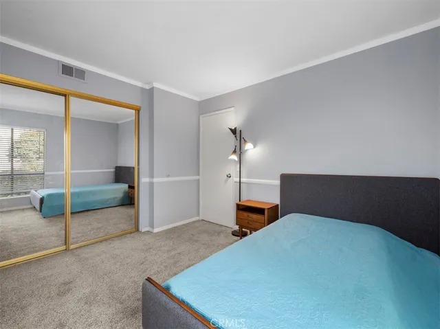 a bedroom with a bed and with view of bathroom