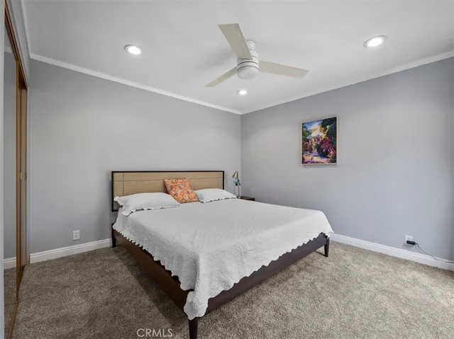 a bedroom with a bed and a painting on the wall