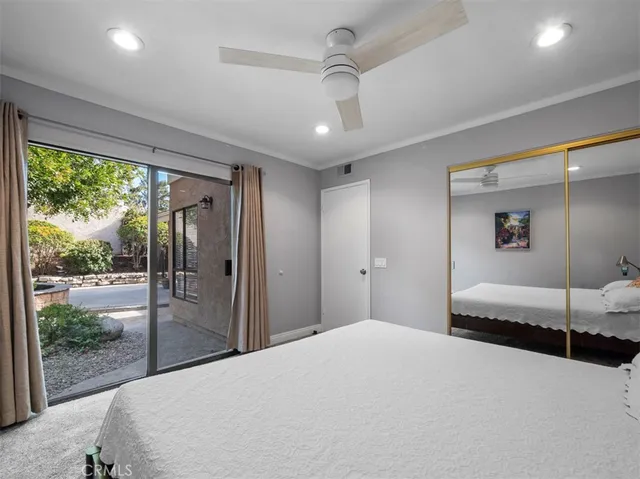 a bedroom with a large bed and a large window