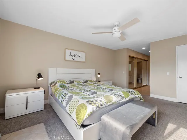 a bedroom with a bed and a couch