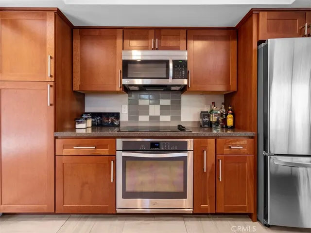 a kitchen with stainless steel appliances granite countertop a refrigerator stove and microwave