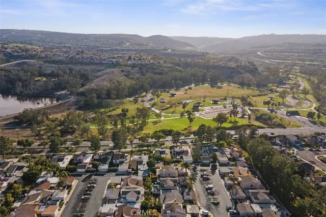 an aerial view of residential house with parking and yard