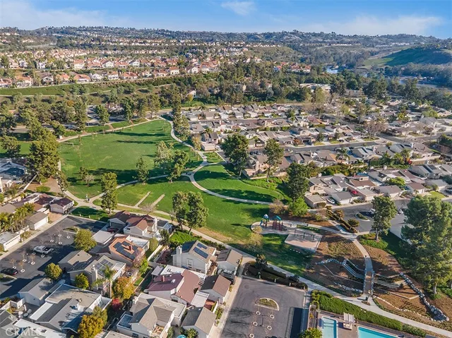 an aerial view of residential houses with outdoor space and river