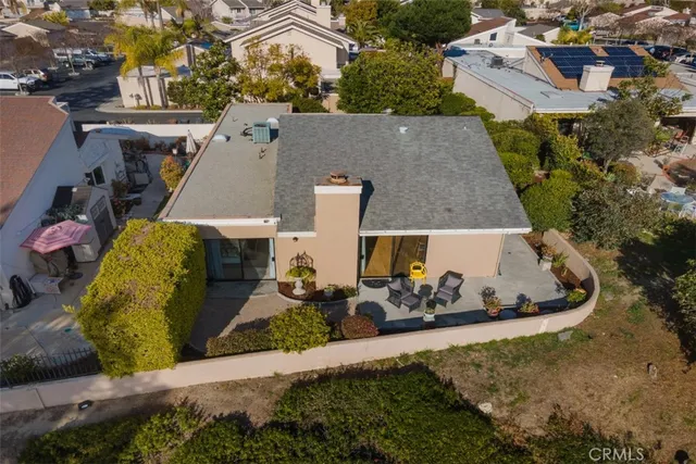 an aerial view of a house with large trees
