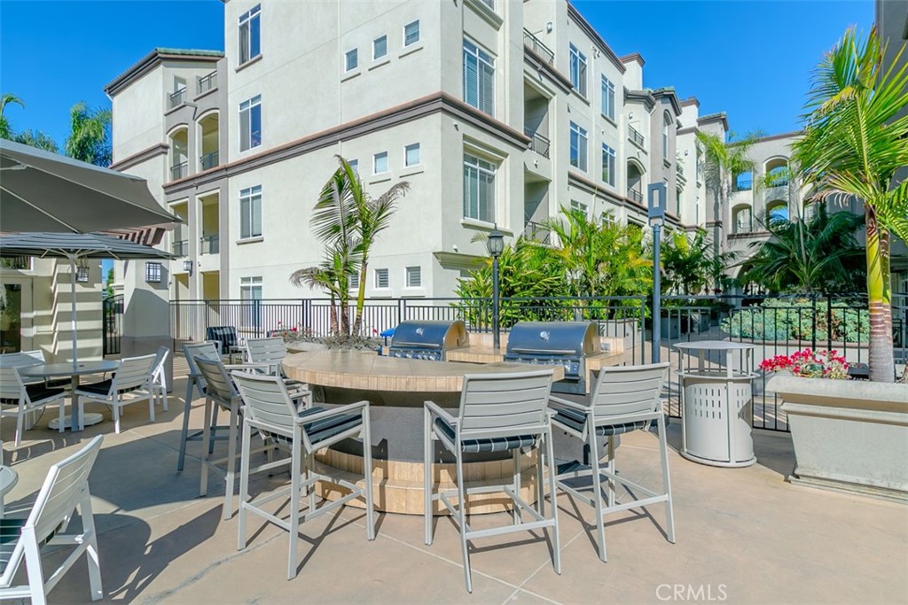 9293 Regents Road, Unit C303 La Jolla, CA 92037 - Photo 12 of 26 a view of a patio with a table and chairs and potted plants