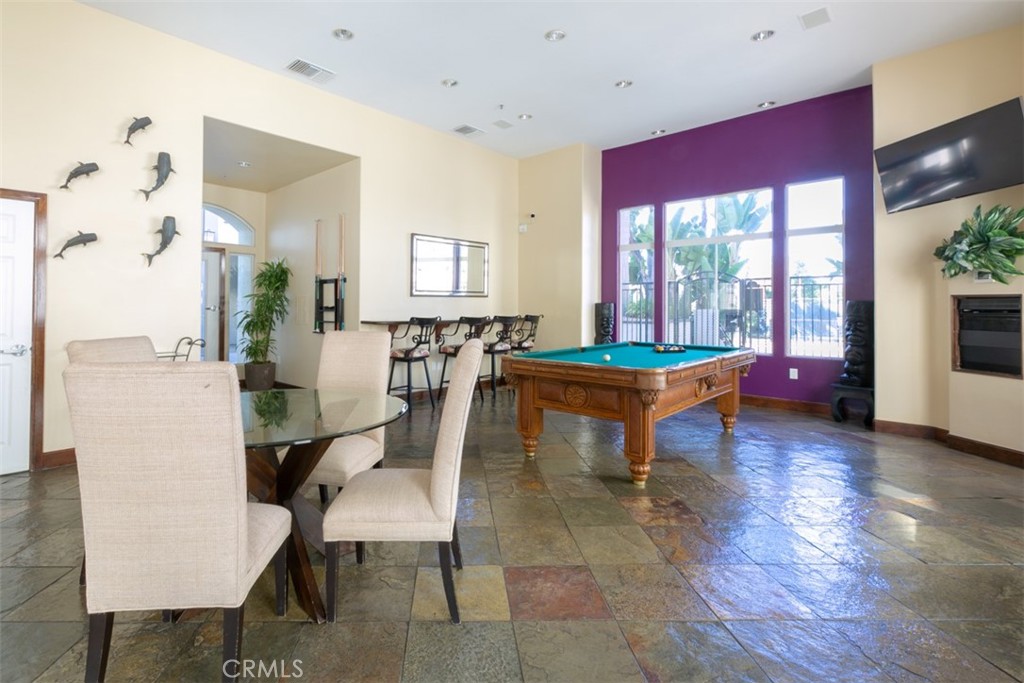 9293 Regents Road, Unit C303 La Jolla, CA 92037 - Photo 15 of 26 a living room with furniture a table and a potted plant