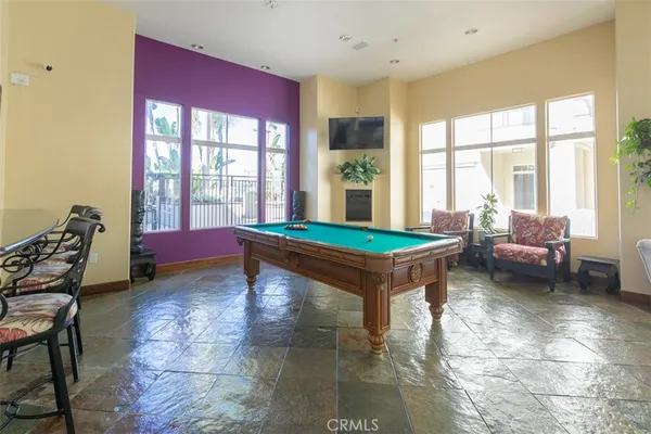 a living room with furniture a rug and a floor to ceiling window