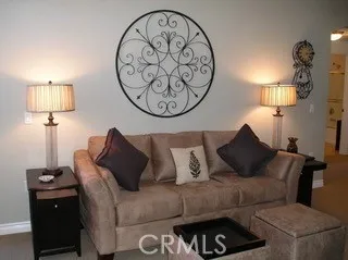 a living room with furniture a lamp and a window