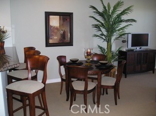 9293 Regents Road, Unit C303 La Jolla, CA 92037 - Photo 5 of 26 a dining room with furniture and potted plants