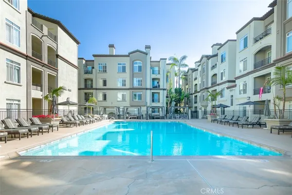 a swimming pool view with outdoor seating